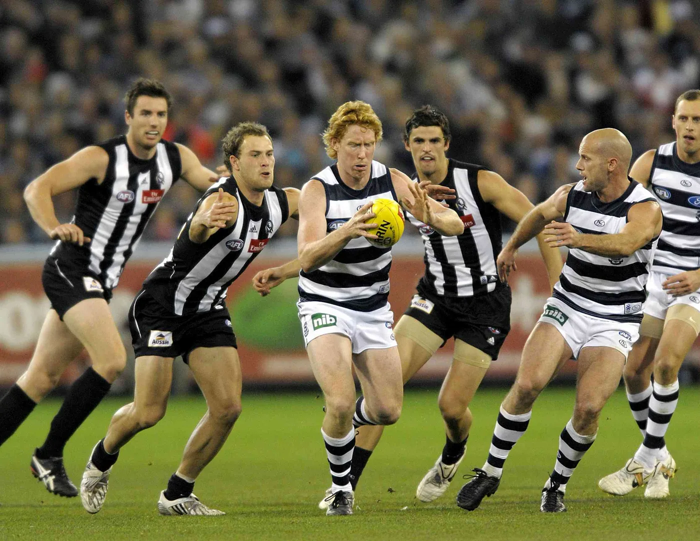 Athletes contest physical position during AFL grand finals competition.