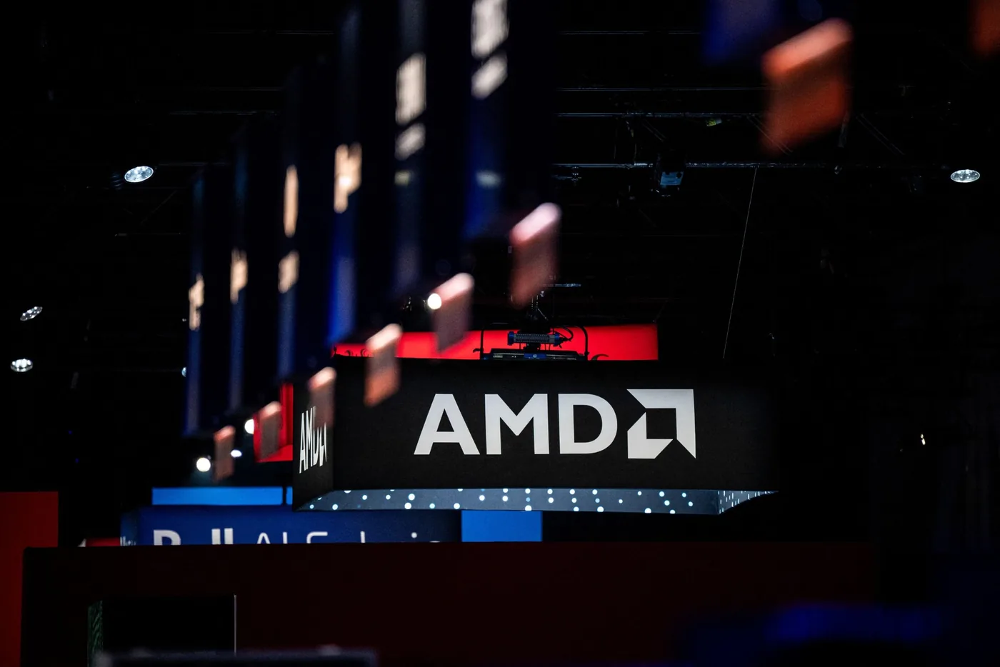 AMD logo and semiconductor hardware as AMD beats Intel to a one trillion dollar market valuation.