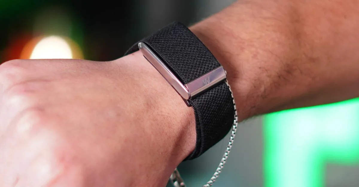 Apple Watch next to a Whoop band illustrating smartwatch and Apple fitness tracker differences.