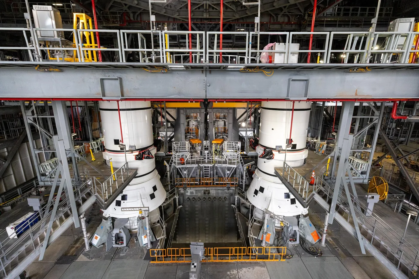 Technicians process Artemis 3 flight hardware and solid rocket booster segments at Kennedy Space Center.