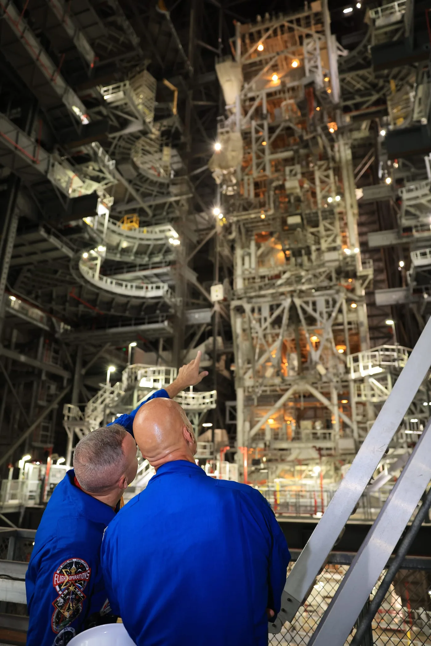 Astronauts Randy Bresnik and Luca Parmitano observe Artemis III booster stacking operations at NASA Kennedy Space Center.