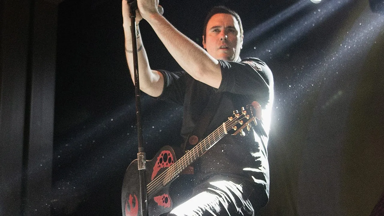 Breaking Benjamin frontman Benjamin Burnley performing on stage.