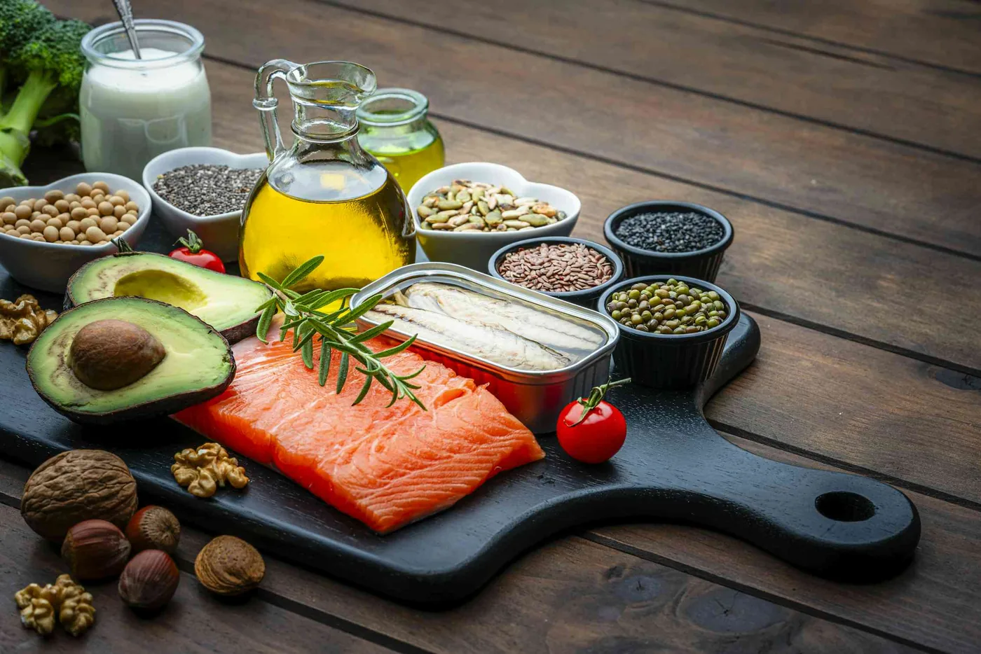 Nutrient-dense foods including salmon, nuts, and avocados that support dietary cholesterol control.