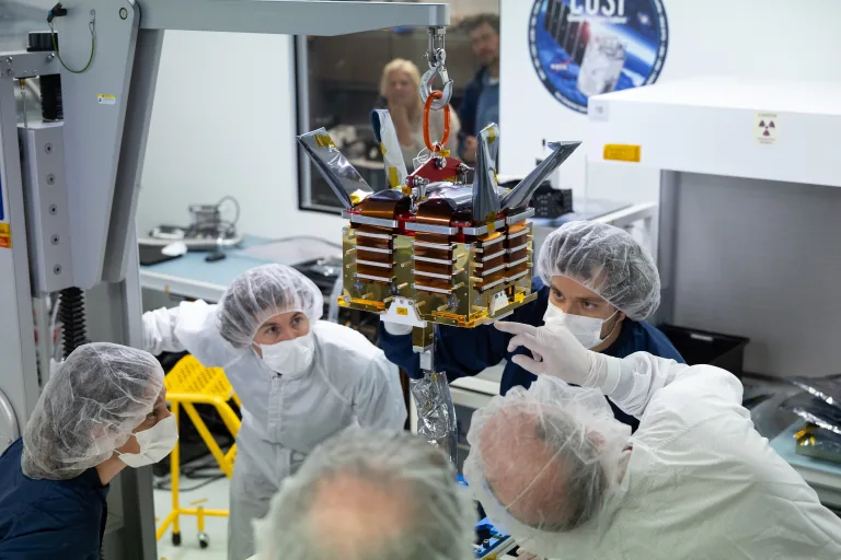 Laboratory technicians lifting the COSI space telescope detector box at UC Berkeley