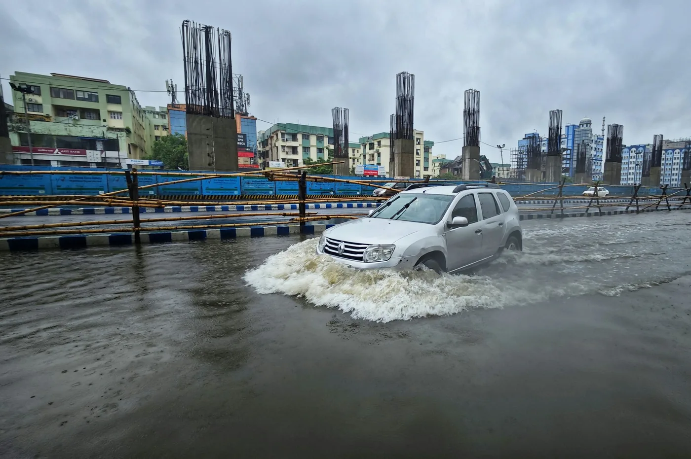 A vehicle stranded in floodwater demonstrates the hazards of driving through water.