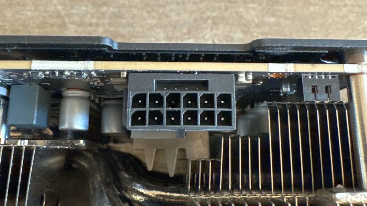 The damaged 16-pin power connector on a melted RTX 5090 graphics card.