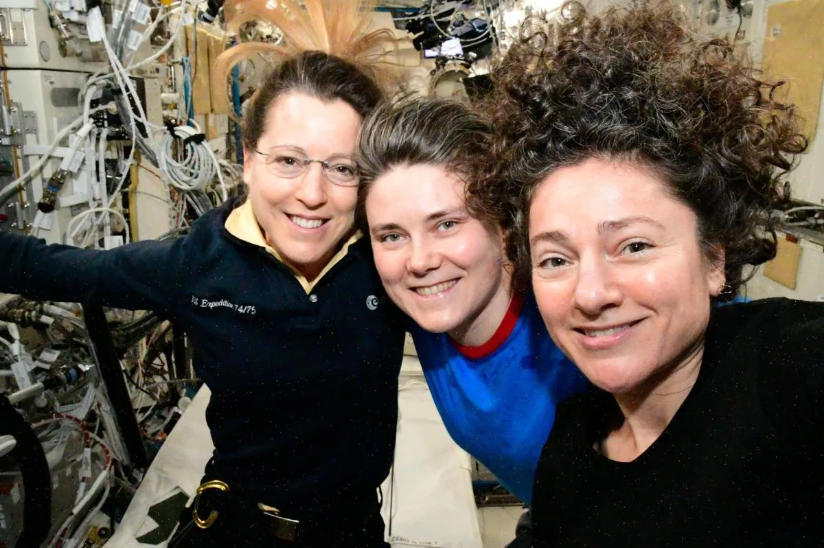 International Space Station crew members conducting orbital research during Expedition 75.