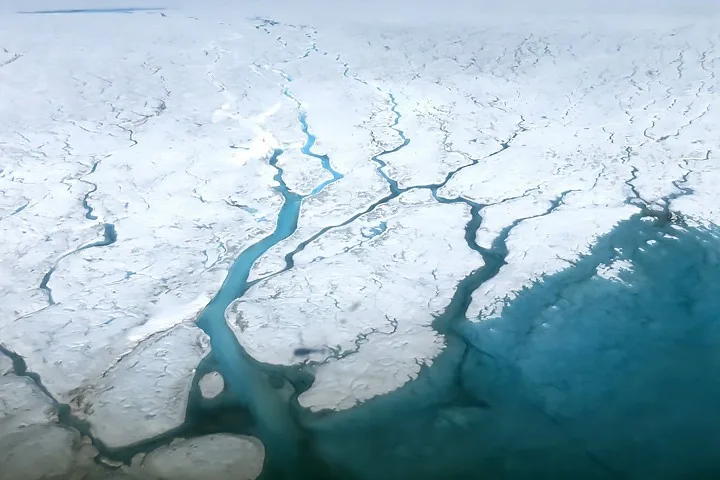 NASA Earth Observatory aerial documentation of glacial surface hydrology and melting water channels across Greenland.