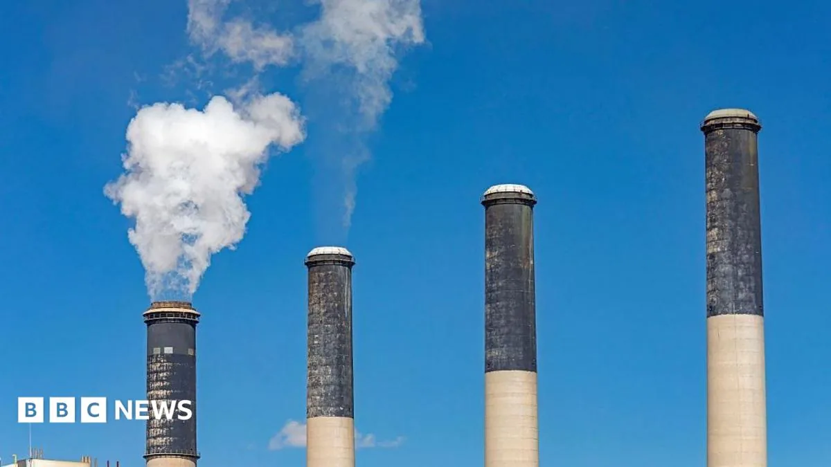 Industrial cooling towers and smokestacks tied to debates over power plant emissions.