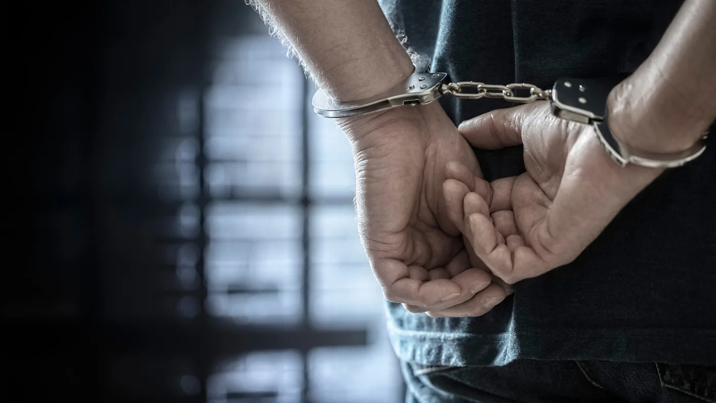Handcuffs illustrating the detention of an alleged ShinyHunters hacker by Dutch law enforcement