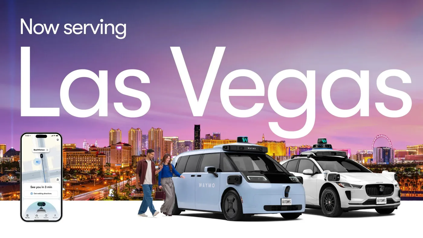 Waymo autonomous minivans navigating city street corridors.