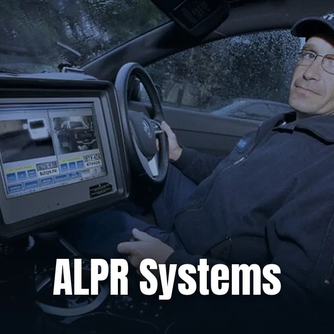 A police officer sits inside a vehicle equipped with an onboard automated license plate reader terminal