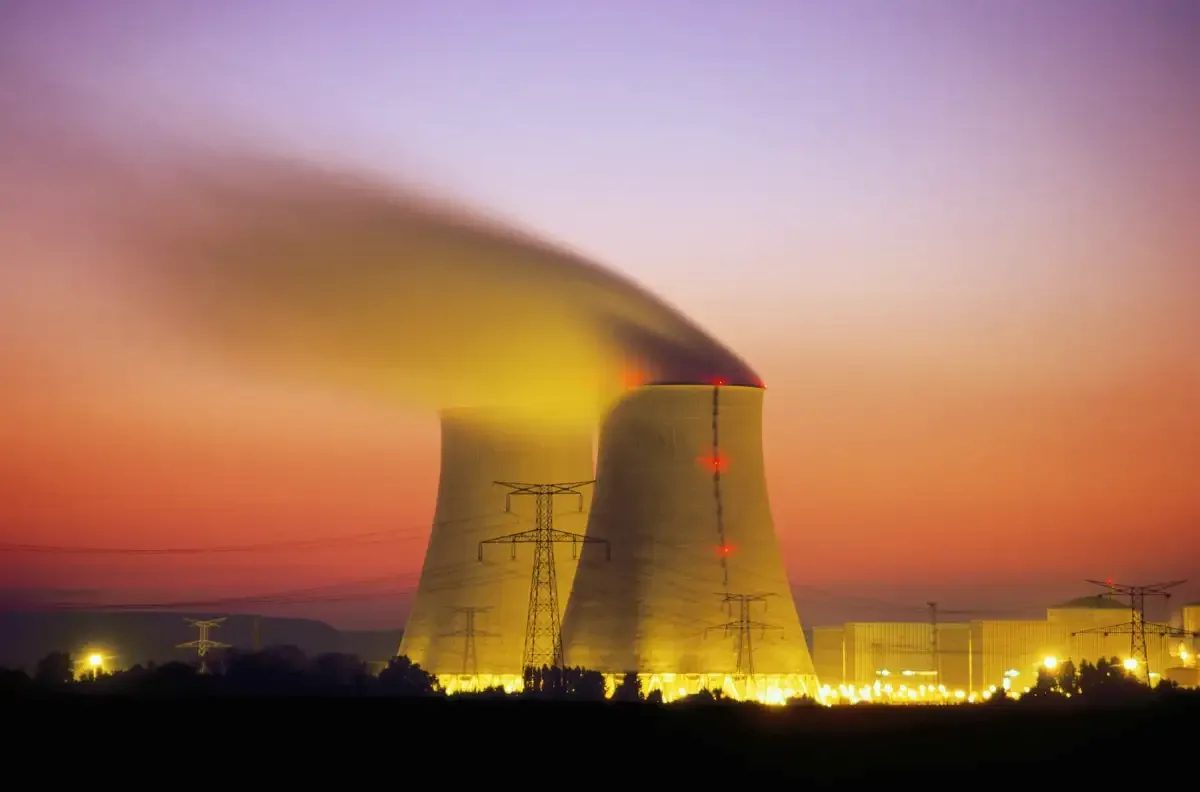 Cooling towers and electrical infrastructure at a power generation facility.