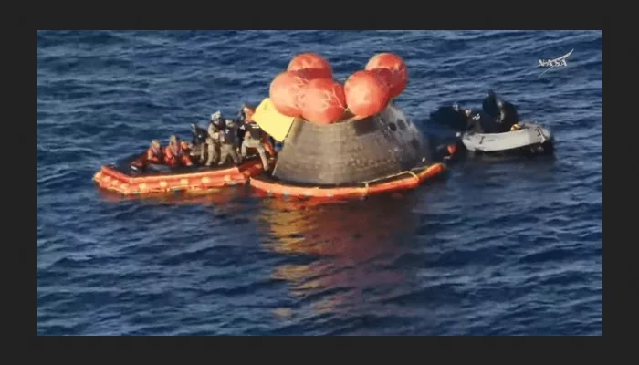The Orion capsule Integrity floating in the Pacific Ocean after splashdown