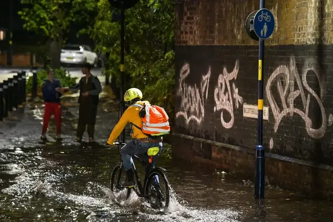 Pouring rain drenches urban streets in Birmingham as storms move into central England.