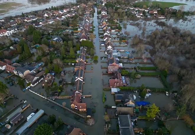 An aerial view of floodwater surrounding homes on a residential street in Wraysbury highlighting community autumn flood risk.