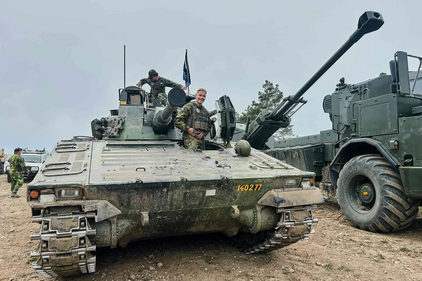 Swedish armed forces personnel look out from an armoured vehicle during military exercises in Gotland.