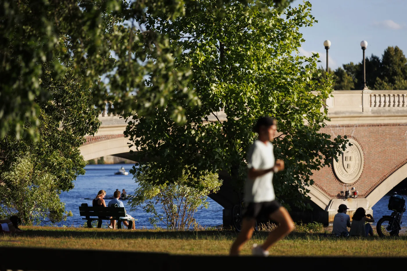 Visitors gathering near the Weeks Footbridge spanning the Charles River in Cambridge.