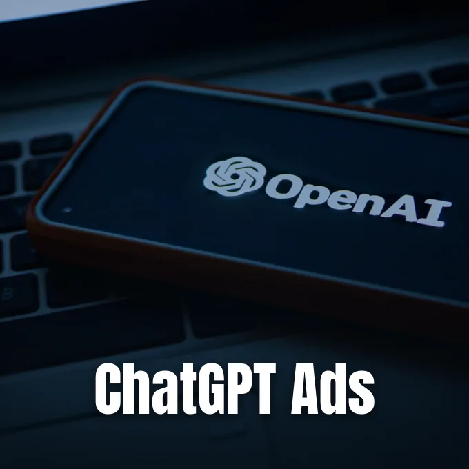 A smartphone displaying the OpenAI logo resting on a laptop keyboard in dim lighting.