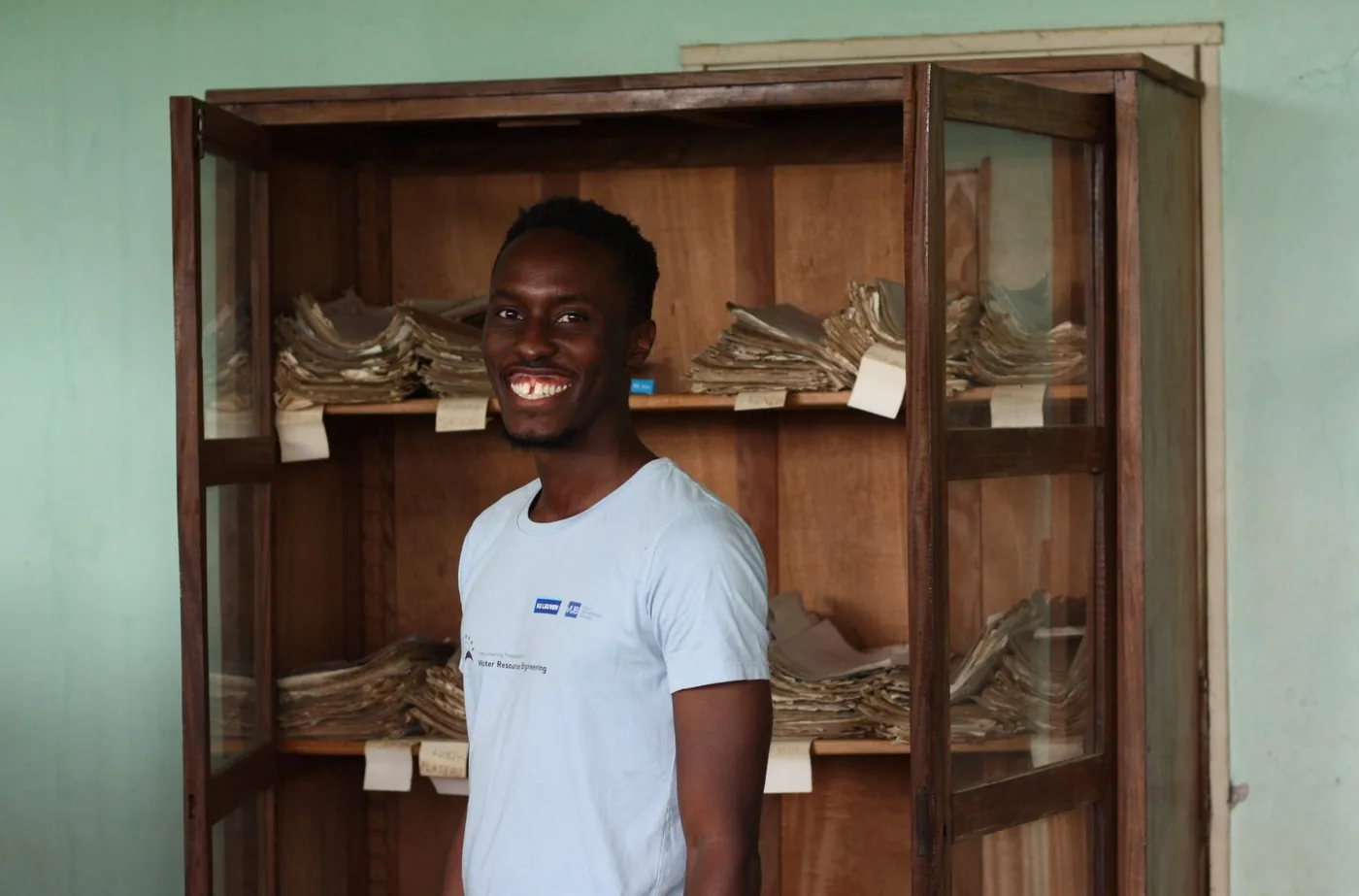 Derrick Muheki examining weather records at the INERA archive in Yangambi