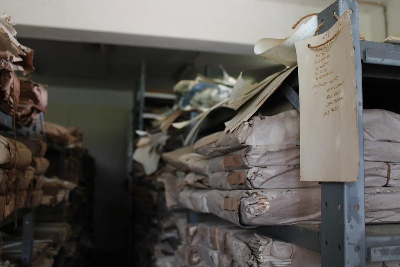 Shelves holding handwritten meteorological logs at the INERA archive