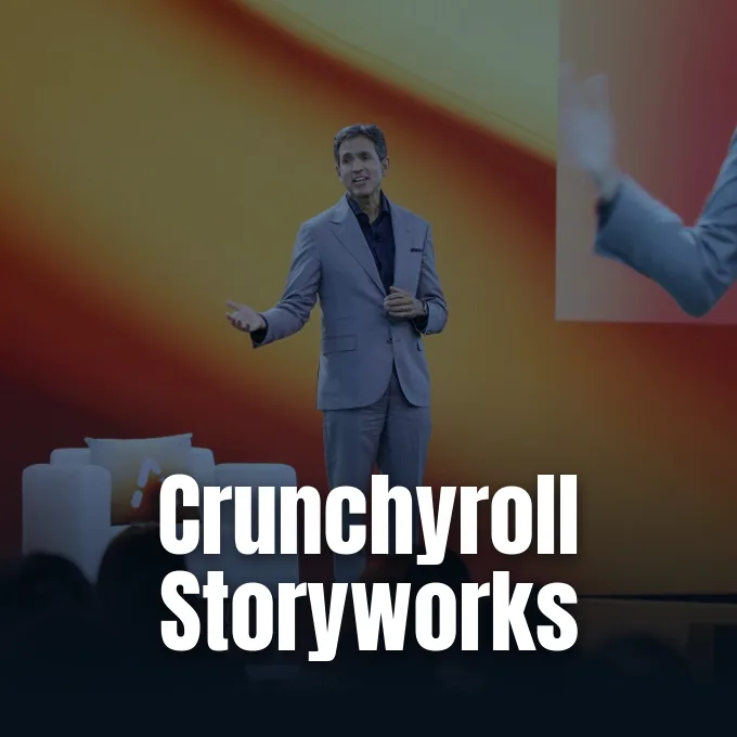 A speaker in a gray suit presenting on stage at the Crunchyroll Anime Future Forum conference