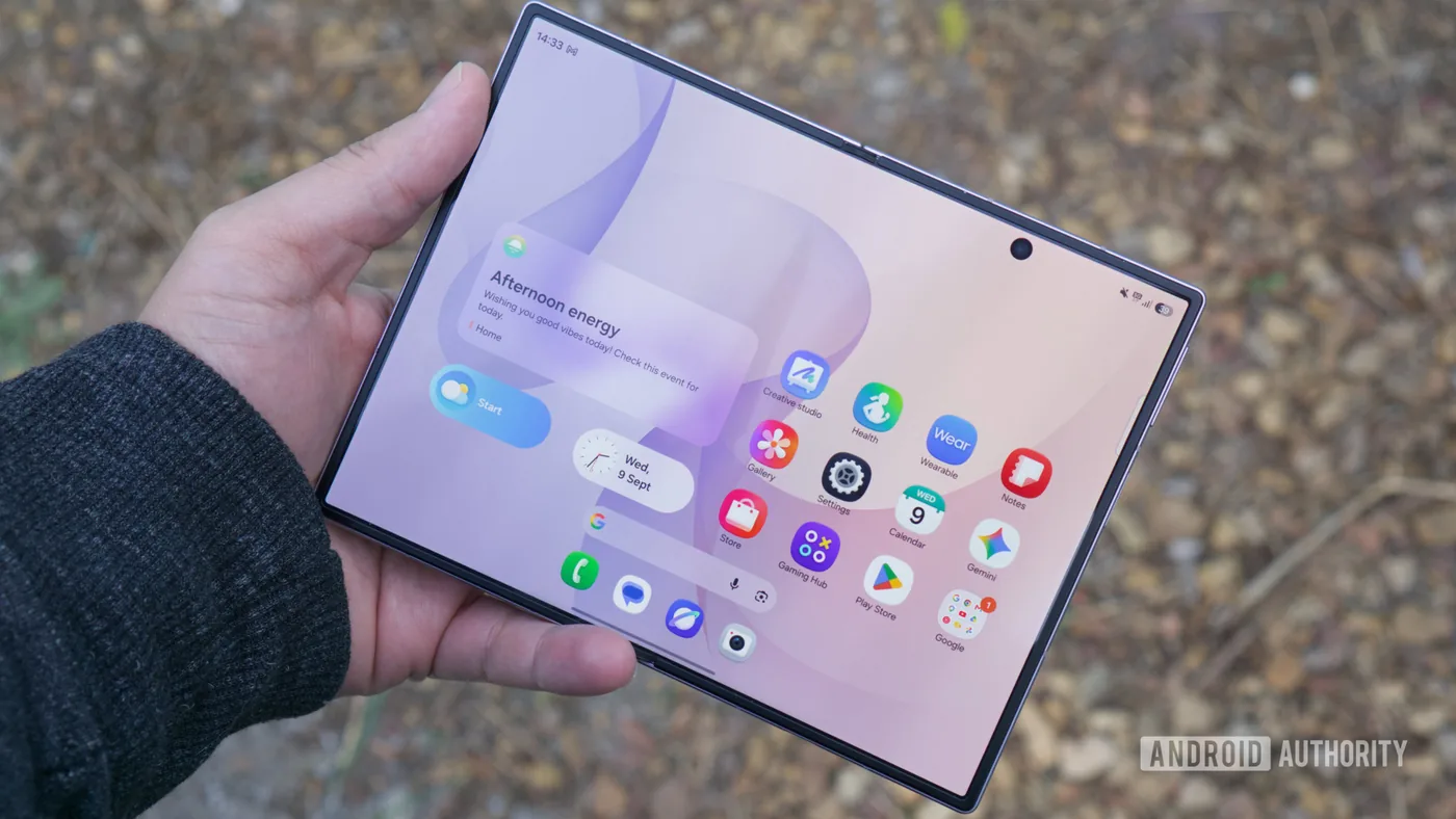 A user holding the Samsung Galaxy Z Fold 8 in hand to show the wide inner display.