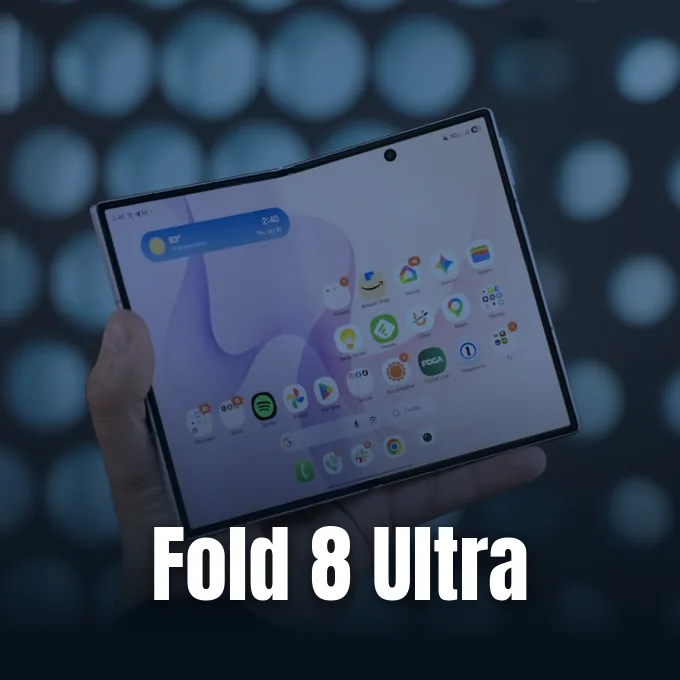 A person holding an unfolded foldable smartphone displaying the home screen against a blurred background.