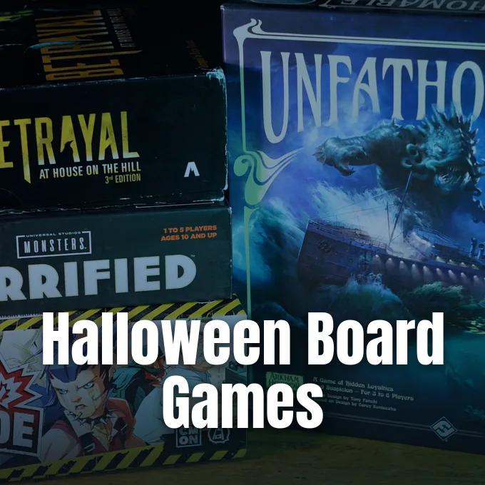 A stack of horror-themed tabletop board game boxes including Betrayal at House on the Hill and Unfathomable.