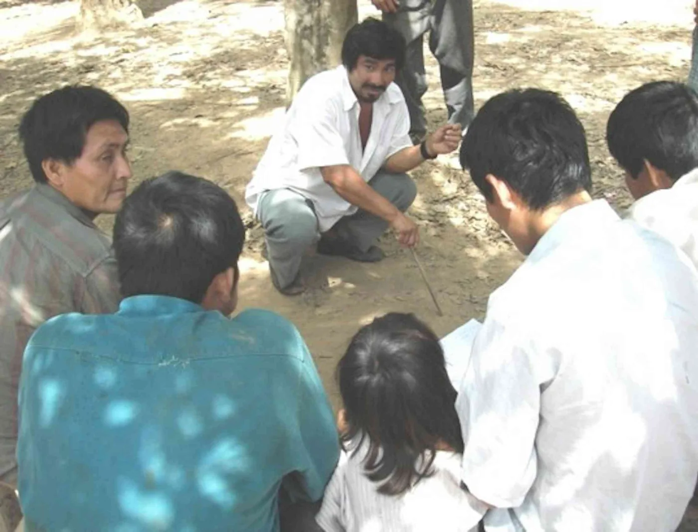A circle of Tsimane villagers holding an open community discussion in Bolivia.