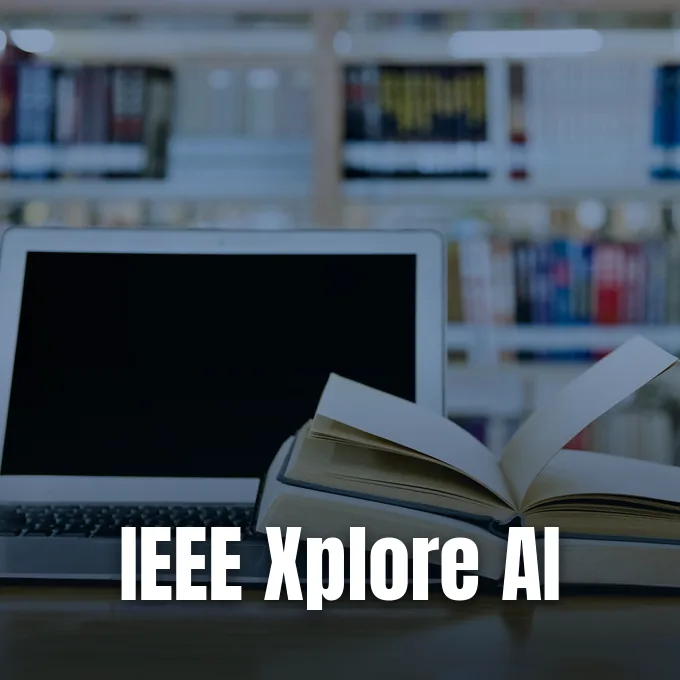 An open book and a laptop computer rest on a desk against a blurred library background.