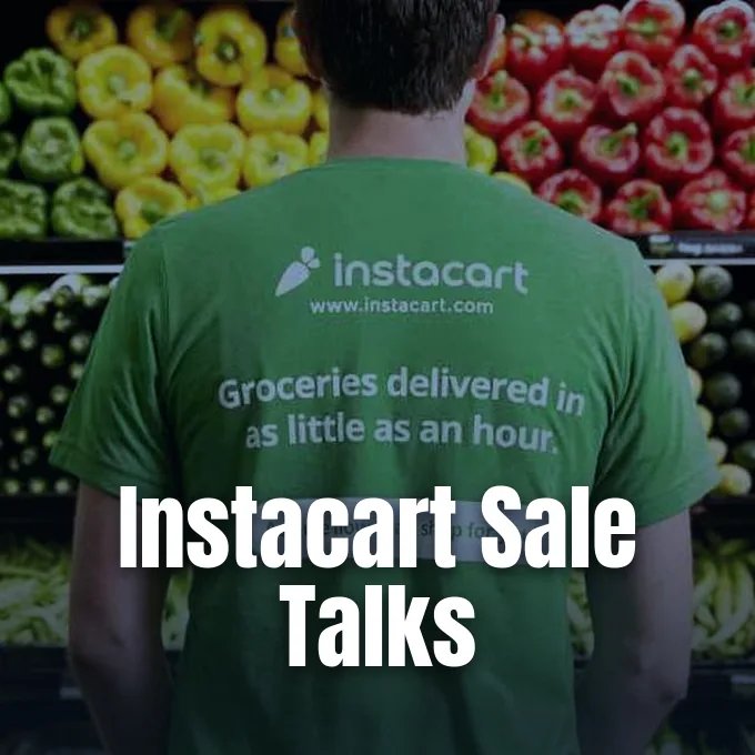A man wearing a green Instacart shirt standing in front of fresh grocery store produce