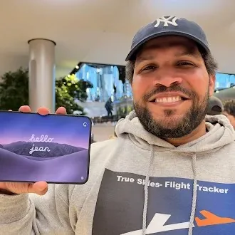 Customer holding an iPhone Duo with a personalized welcome greeting