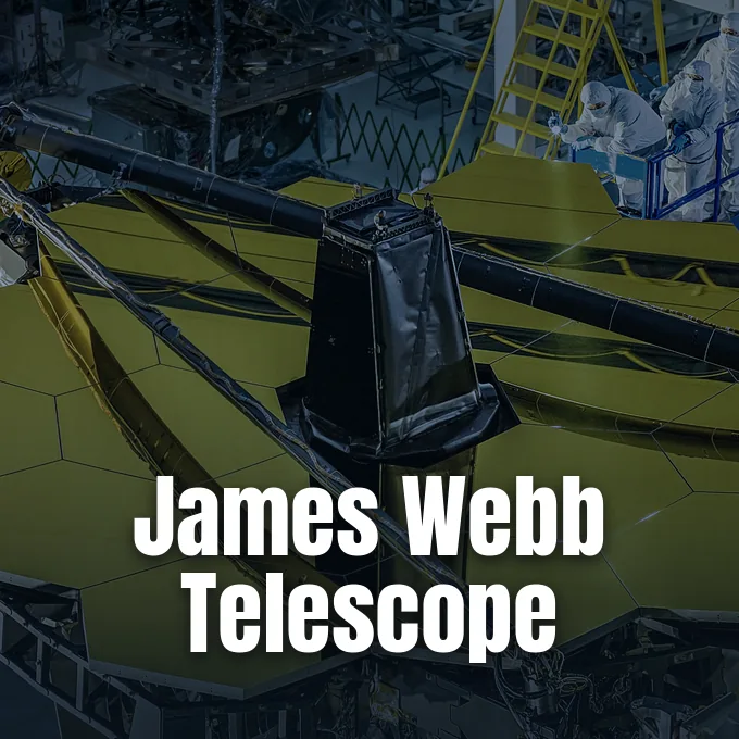 Engineers in protective cleanroom suits inspect the golden hexagonal mirrors of the James Webb Space Telescope.