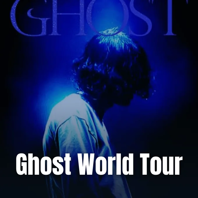 Japanese musician Kenshi Yonezu silhouetted in dramatic blue lighting against a dark background.