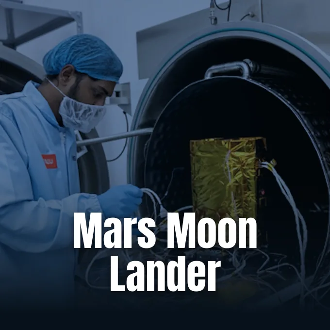 An engineer in cleanroom attire works on space hardware inside a thermal vacuum testing chamber.