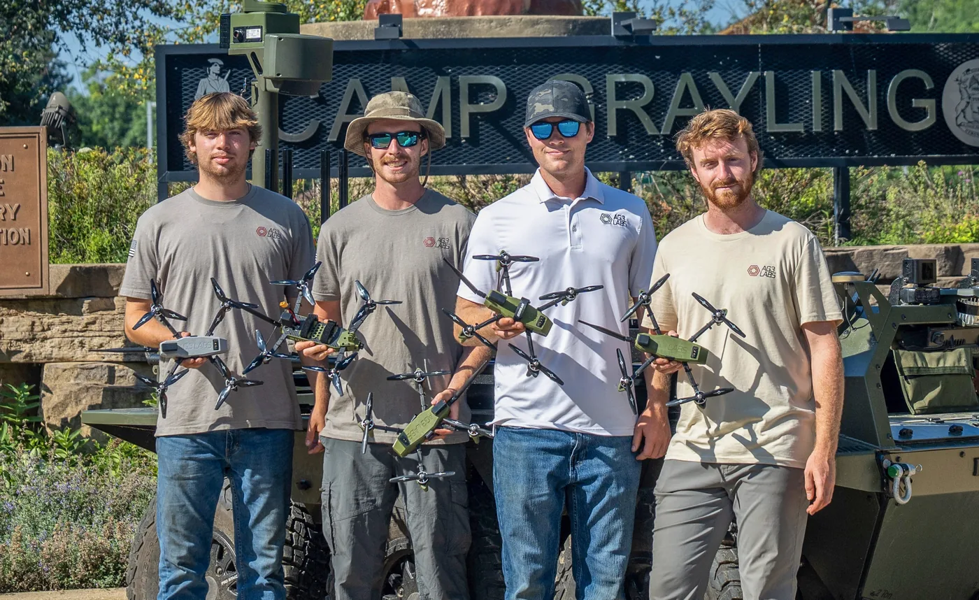 Engineering team members holding flight hardware after completing a NASA drone challenge project.