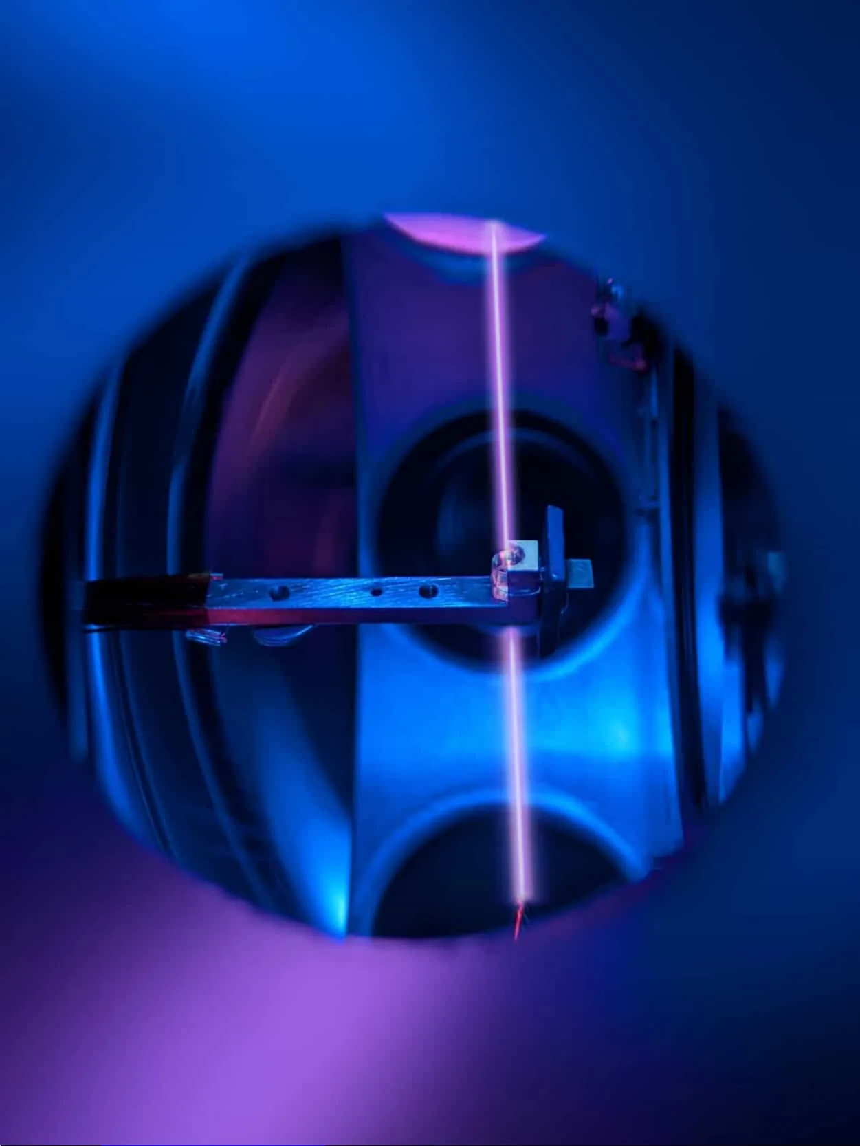 A calcium fluoride crystal doped with thorium-229 illuminated during laser excitation experiments.