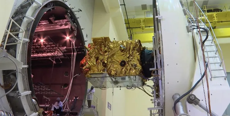 Spacecraft undergoing vibration testing at an ISRO laboratory