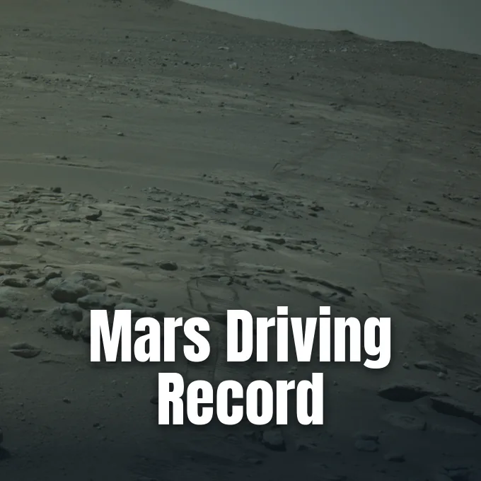 Rover tracks cut across a rocky, sloping terrain on the surface of Mars.