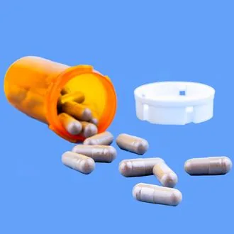 Pills and open bottle in a studio shot from coverage of the placebo effect.