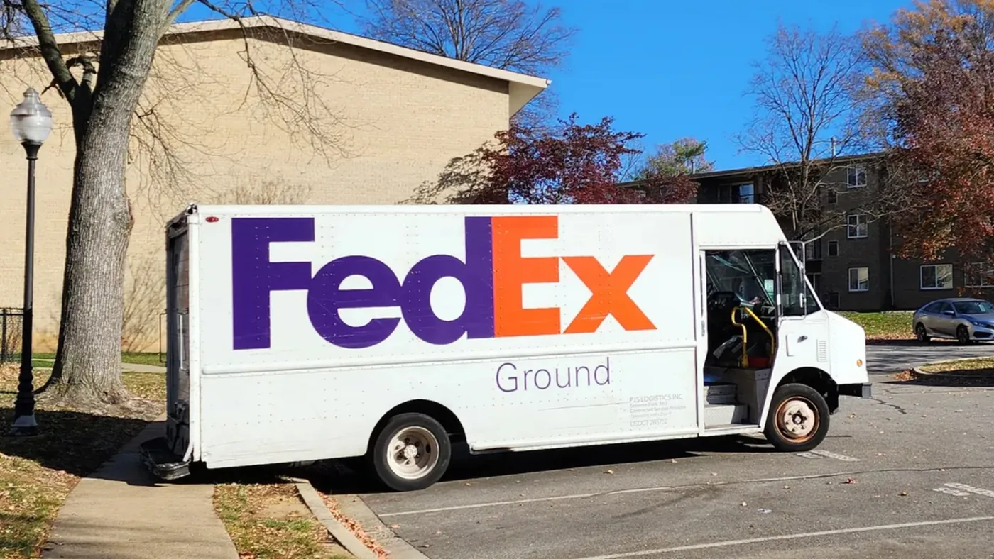 A FedEx Ground transport vehicle in transit.