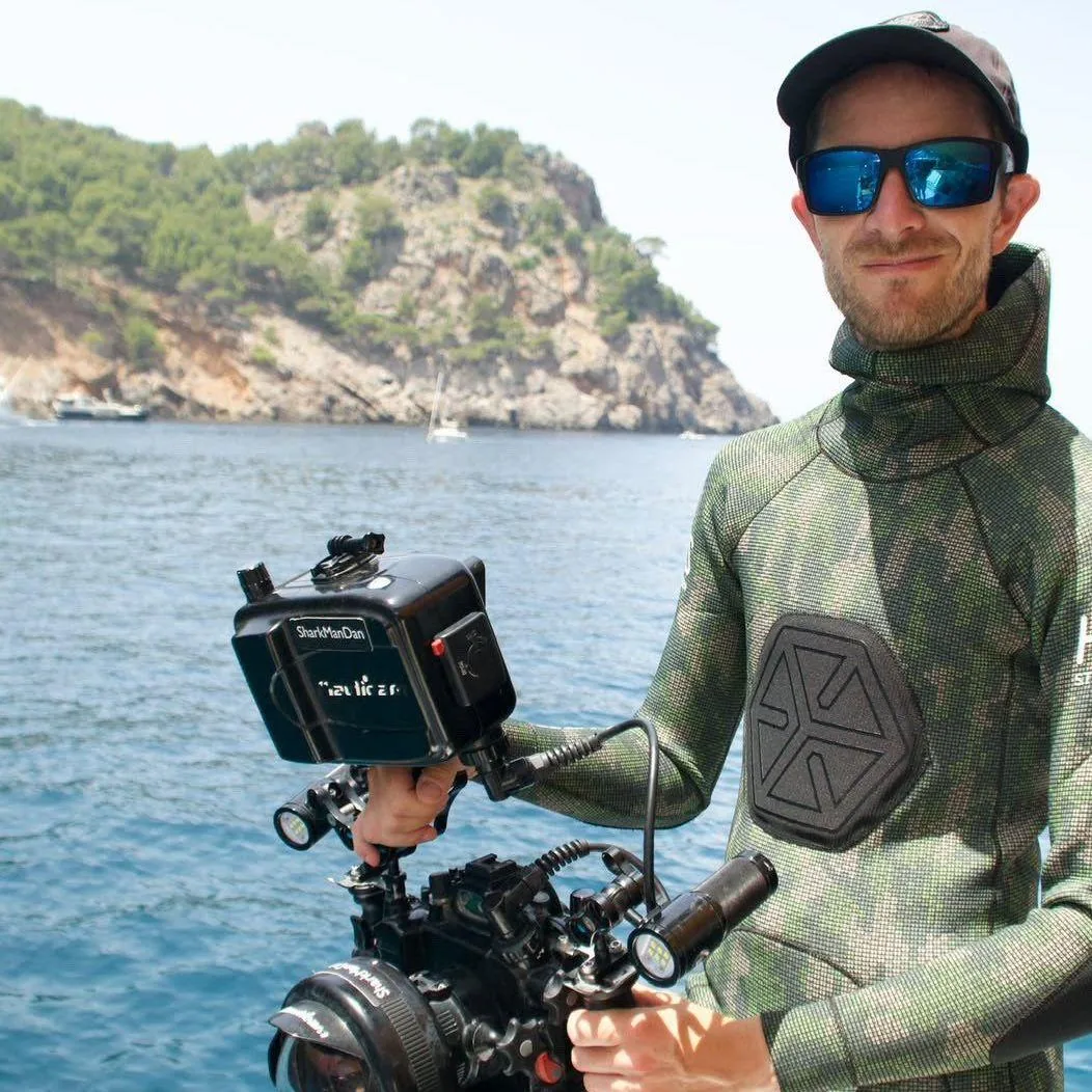 Dan Abbot holding a camera during marine fieldwork in Pembrokeshire waters