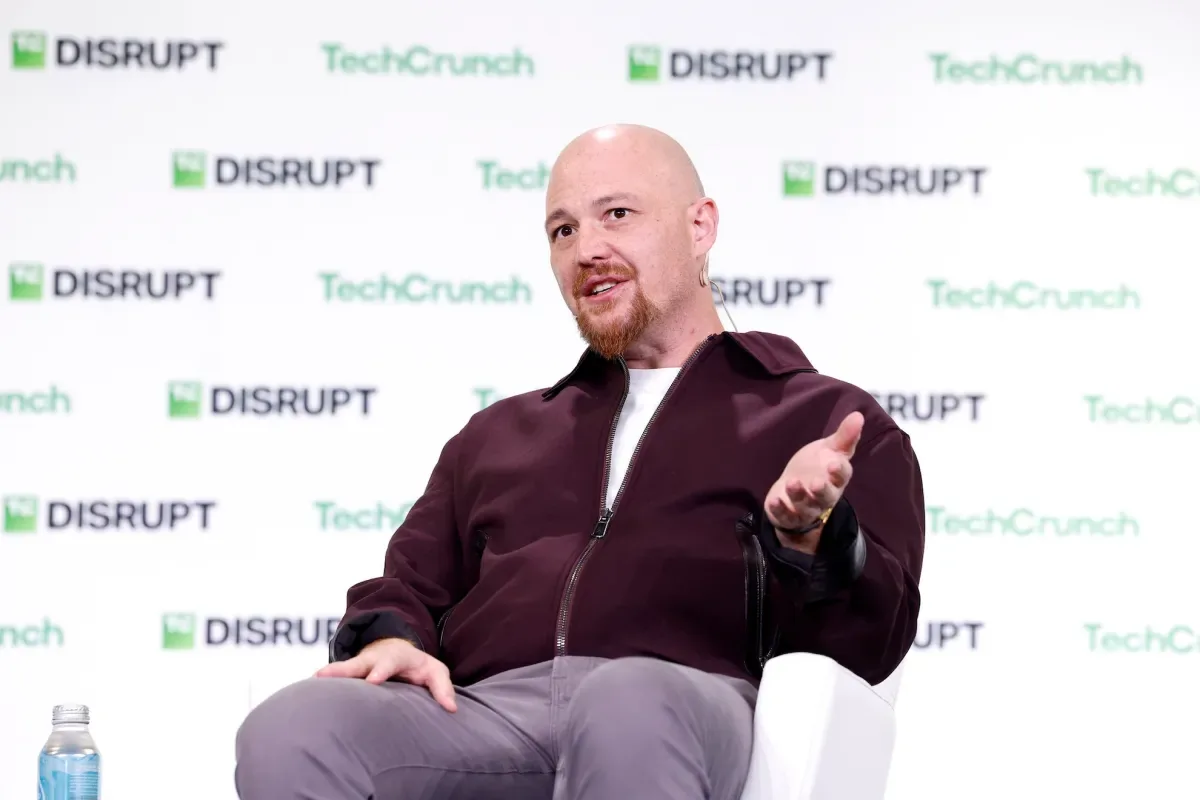 Amjad Masad speaking onstage about Replit Agent at TechCrunch Disrupt.