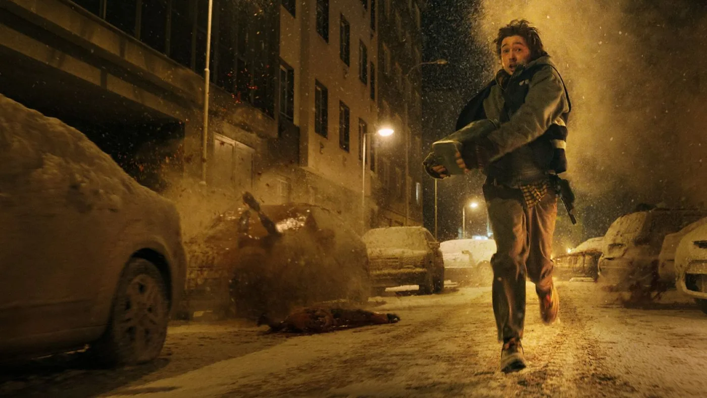 Bryan running toward shelter during an outbreak in the Resident Evil movie
