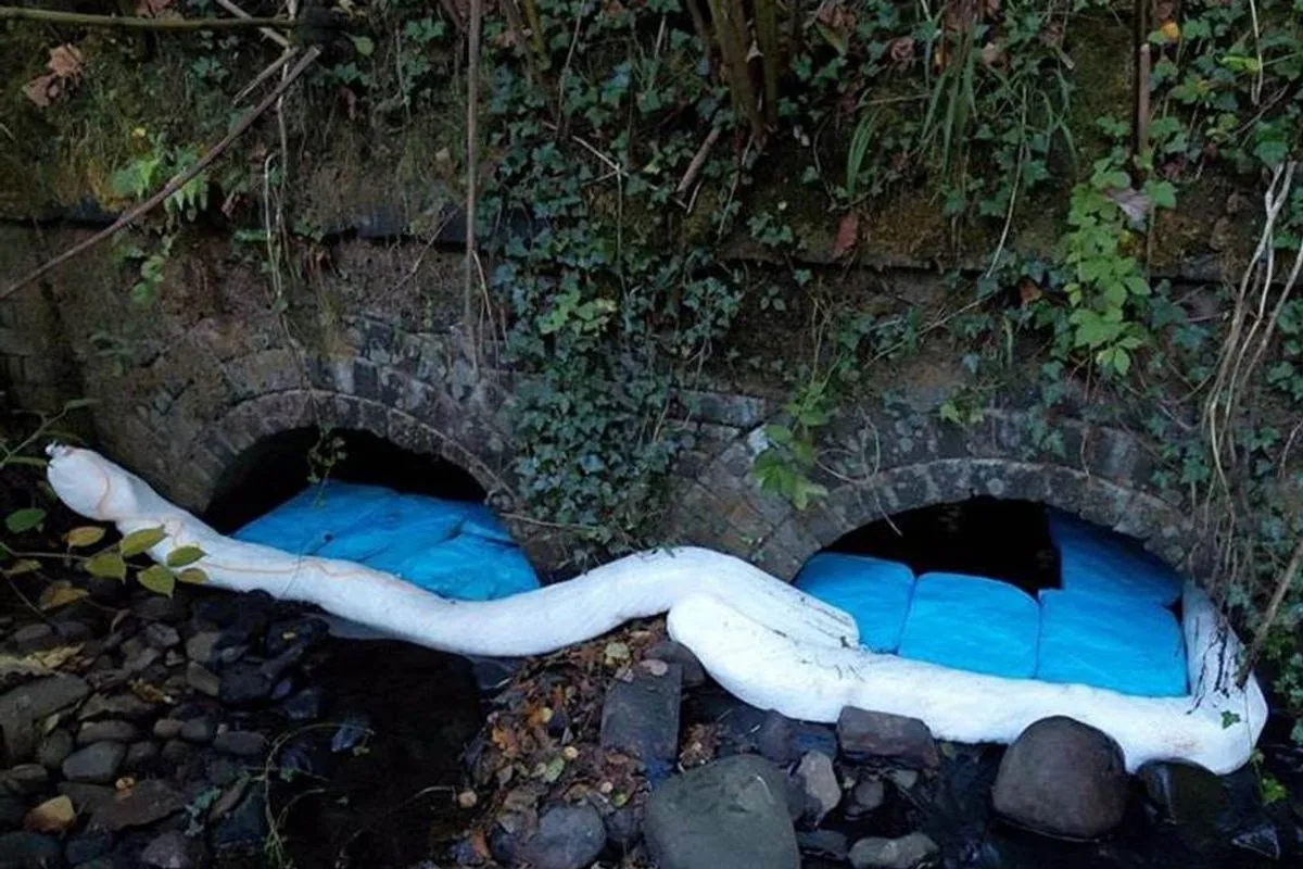 Blue absorbent pads placed under a bridge structure to block kerosene runoff