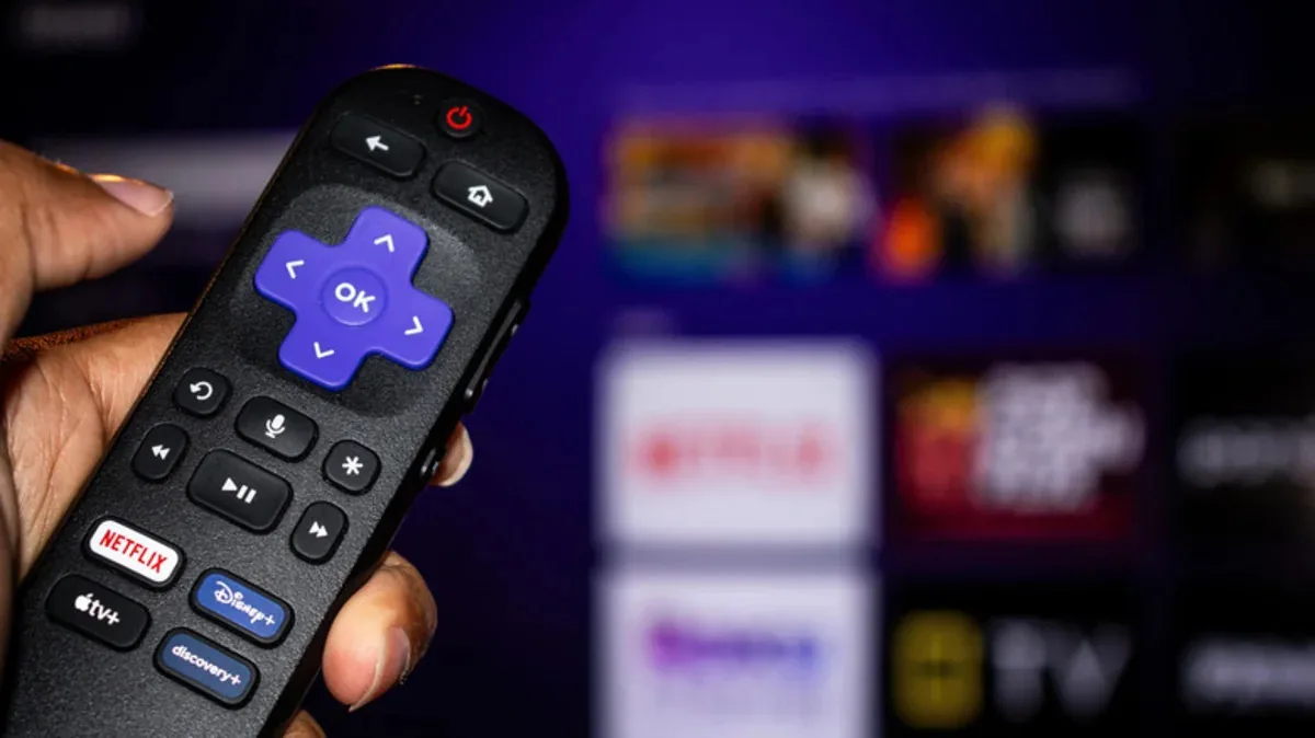 Handheld Roku streaming remote showing directional navigation pad and shortcut keys