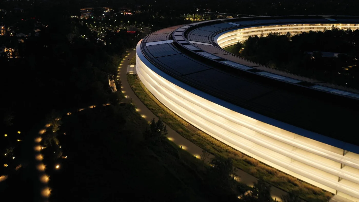 Aerial view of the circular Apple Park headquarters at dusk.