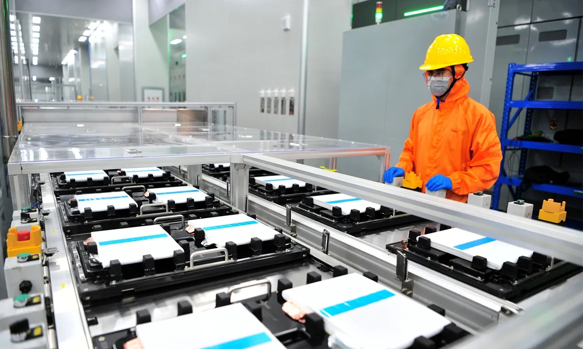 A technician inspects lithium cells at an industrial manufacturing plant in Hubei.