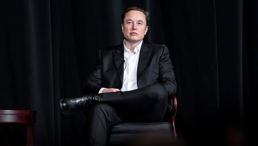 Elon Musk speaks at an event before announcing his plan to distribute SpaceX shares.